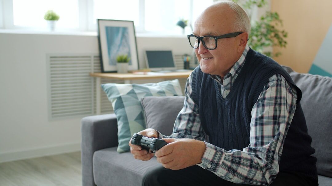 Senior man checking blood pressure at home with a monitor