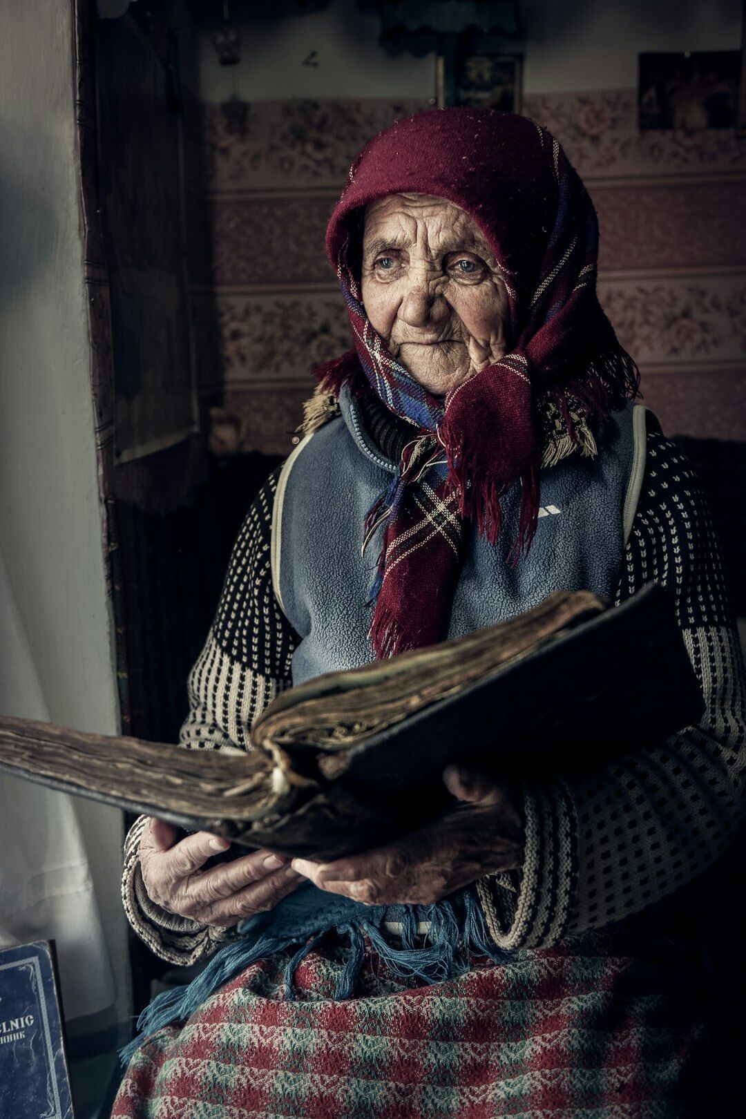 Senior woman reviewing pension documents and paperwork at a desk